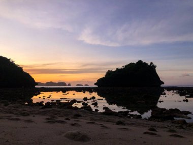 Beautiful sunrise scenery at Teluk Asmara beach Malang, Indonesia 
