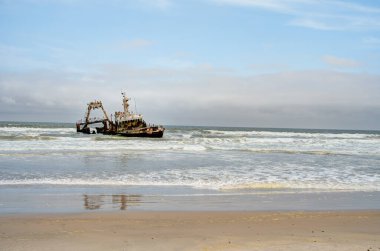 The thrown old ship has sat down on a bank - Namib desert with Atlantic ocean meets near Skeleton coast - Namibia, South Africa
