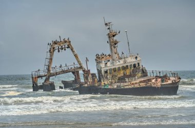 The thrown old ship has sat down on a bank - Namib desert with Atlantic ocean meets near Skeleton coast - Namibia, South Africa