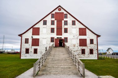 Paspebiac, Canada - July 2 2024 : Historical fishing village in cloudy weather, HDR Image clipart