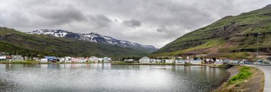 Seydisfjordur, Iceland - July 2 2024 : Historical village in cloudy weather, HDR Image clipart