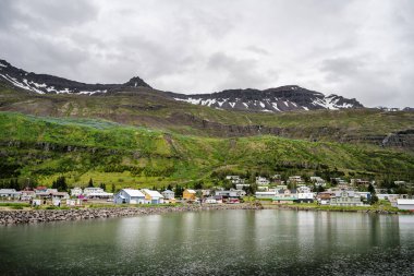 Seydisfjordur, Iceland - July 2 2024 : Historical village in cloudy weather, HDR Image clipart