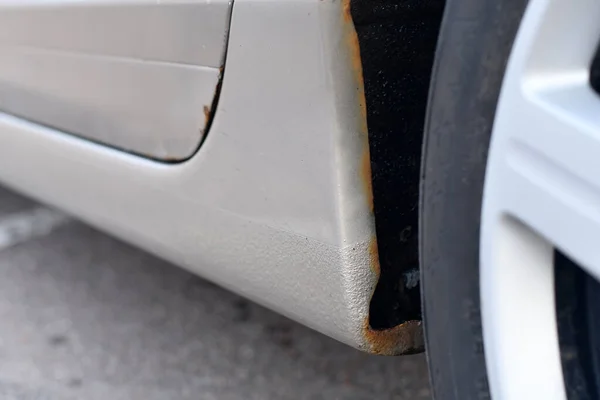 stock image Signs of car corrosion or rust appearing on the rear arches of the car. Selective focus.