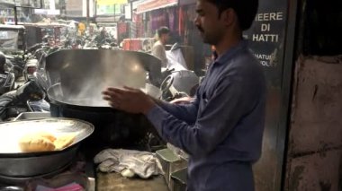 AMRITSAR, INDIA - 18 Mart 2019: Yemek poori ekmeğini elle düzleştirir ve Hindistan 'ın Amritsar kentine yağ koyar