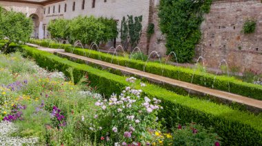 GRENADA, SPAIN-MAY, 1, 2023: a wide view of a fountain in a generalife garden of the ancient palace-fortress alhambra clipart