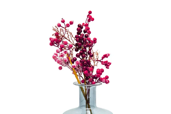 Blue vase with red flowers on the table, isolated on white background.
