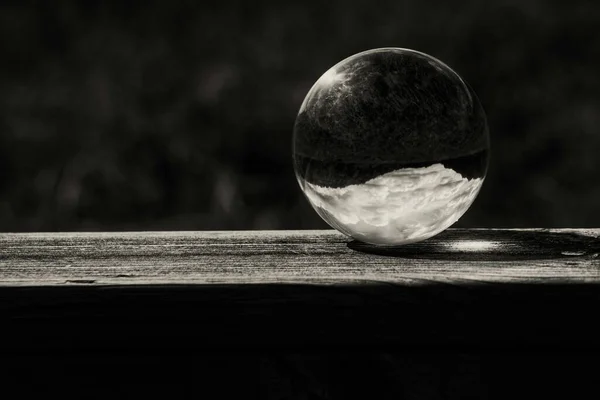 stock image A close up of a crystal ball on wooden hand rail 