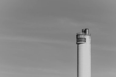 a large tall tower with a cloudy sky