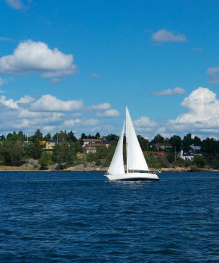 a small boat in front of an island in the archipelago 