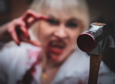 white haired woman holding a bloody hammer 
