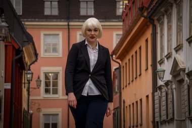 a female standing in front of a building