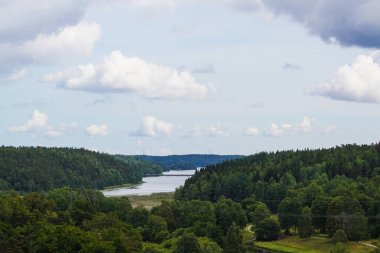 Scenic view of river against cloudy sky