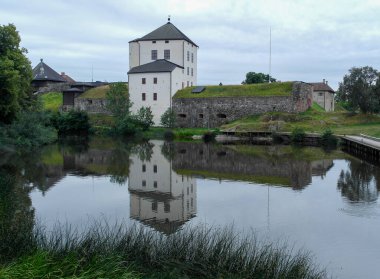 Scenic view of canal by ruin against sky