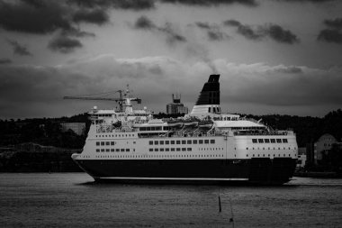 a large ship in a river at a city 