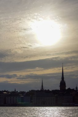 Silhouette of buildings against cloudy sky during sunset