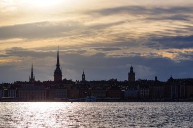 View of buildings at waterfront during sunset