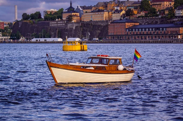 View of old wooden boat in sea at a city