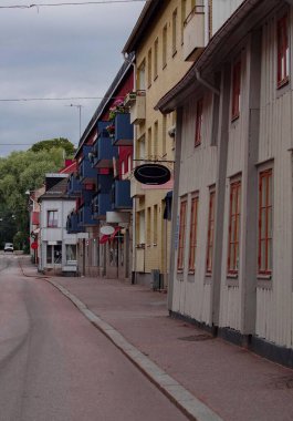 Empty road amidst buildings in city during summer 