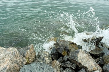 High angle view of waves splashing on rocks