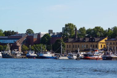 View of buildings and ships by sea against clear sky