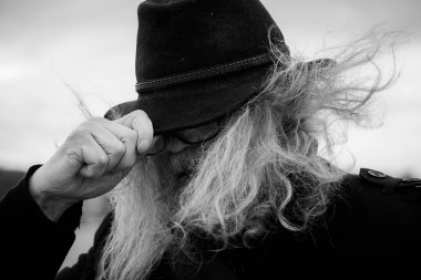 Close up of man wearing hat against sky