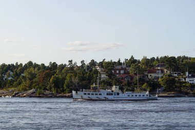 steamboat in front of island in the archipelago