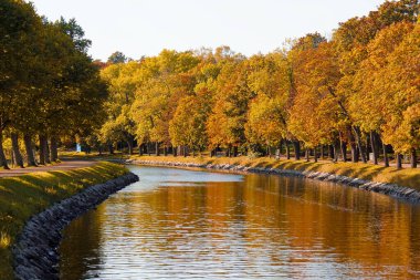 Scenic view of canal by trees against sky during autumn