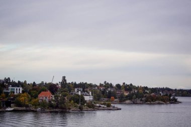 Scenic view of archipelago by buildings against sky