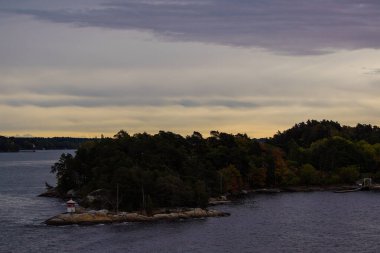 Scenic view of archipelago against sky at sunset
