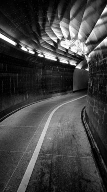 Empty illuminated tunnel in black and white 