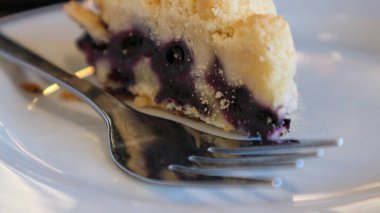close up of blueberry pie with a fork