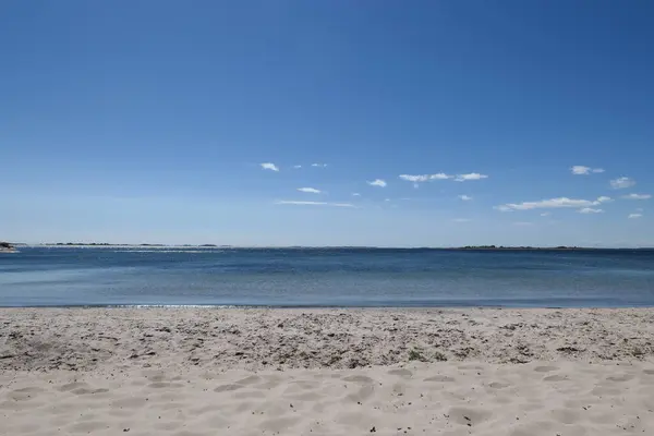 stock image Scenic view of beach against blue sky