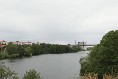 Scenic view of river in city against sky