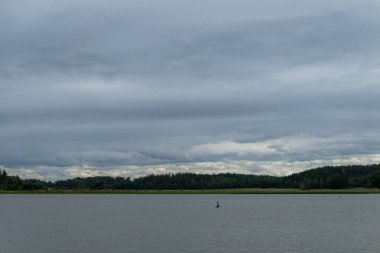 Scenic view of lake against cloudy sky