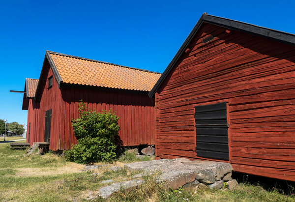 Low angle view of barn against clear blue sky