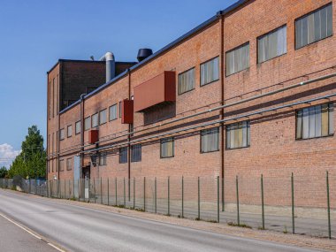 Low angle view of a industrial building next to a road 