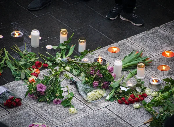 Anma töreninde yerde çiçekler ve mumlar vardı.