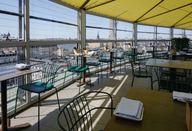 the inside of a restaurant with view over a city 