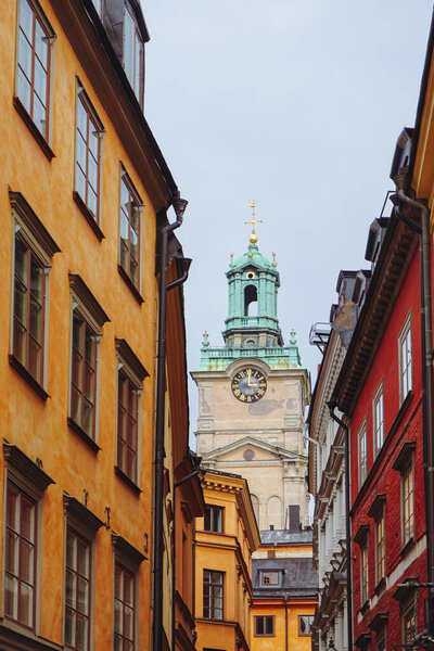 A church tower over seen over buildings 