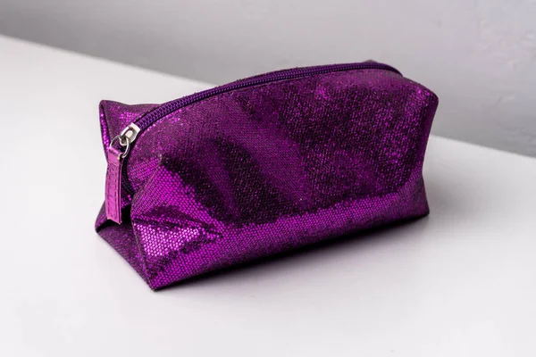Glitter makeup bag isolated on white background