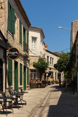 Ünlü, turistik Ege kasabası Alacati 'deki tarihi, geleneksel taş ev ve kafelerin manzarası. Bu, Cesme ilinin bir köyüdür. Güneşli bir yaz günü.
