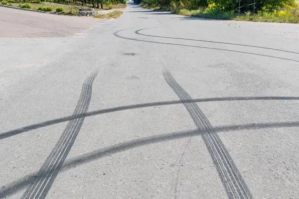 Stock image Black traces of car braking on the asphalt. Close-up of skid marks on the road