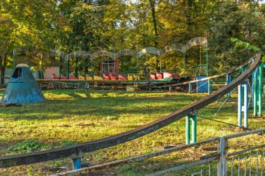 Eski, paslı, terk edilmiş bir lunapark. Bozuk bir karnaval gezisi parkın ortasında unutuldu.