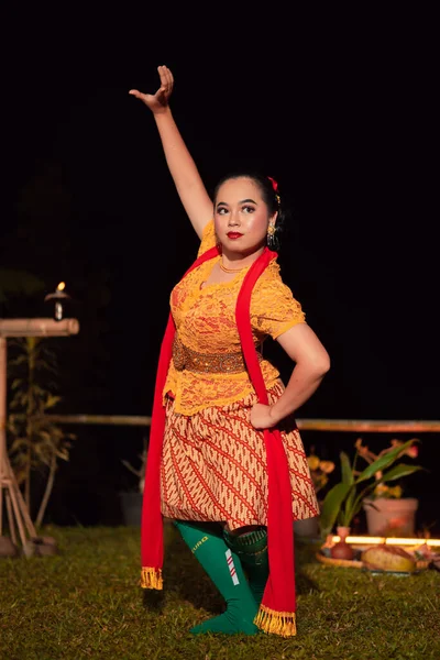 伝統舞踊の衣装を着たインドネシア人女性 ケバヤ 公演後の夜に踊りの動きでポーズをとります — ストック写真