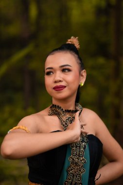 Beautiful face of a Javanese woman in a traditional dance costume before the dance performance begins inside the festival