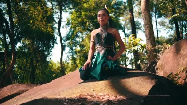 Beautiful Asian Woman Green Costume Sitting Big Rock While Visiting — Video