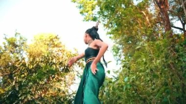 An Asian woman saw someone stealing plants grown in her garden with an angry expression around the forest