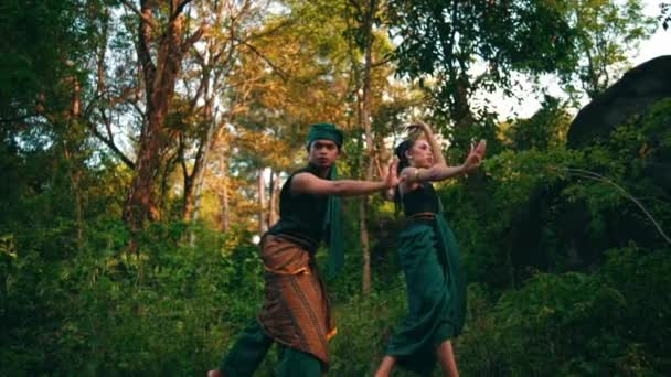 Asian Man Approaches Object Curious Expression While Wearing Green Dress — Vídeo de Stock