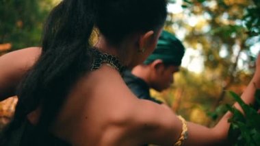 an Asian woman forbids a man to pick fruit in her garden in the morning