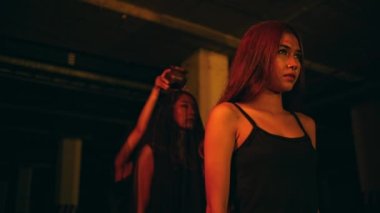 a group of women worshiping satan performs a ritual of pouring blood during the ritual of summoning demon spirits during satanic worship at night